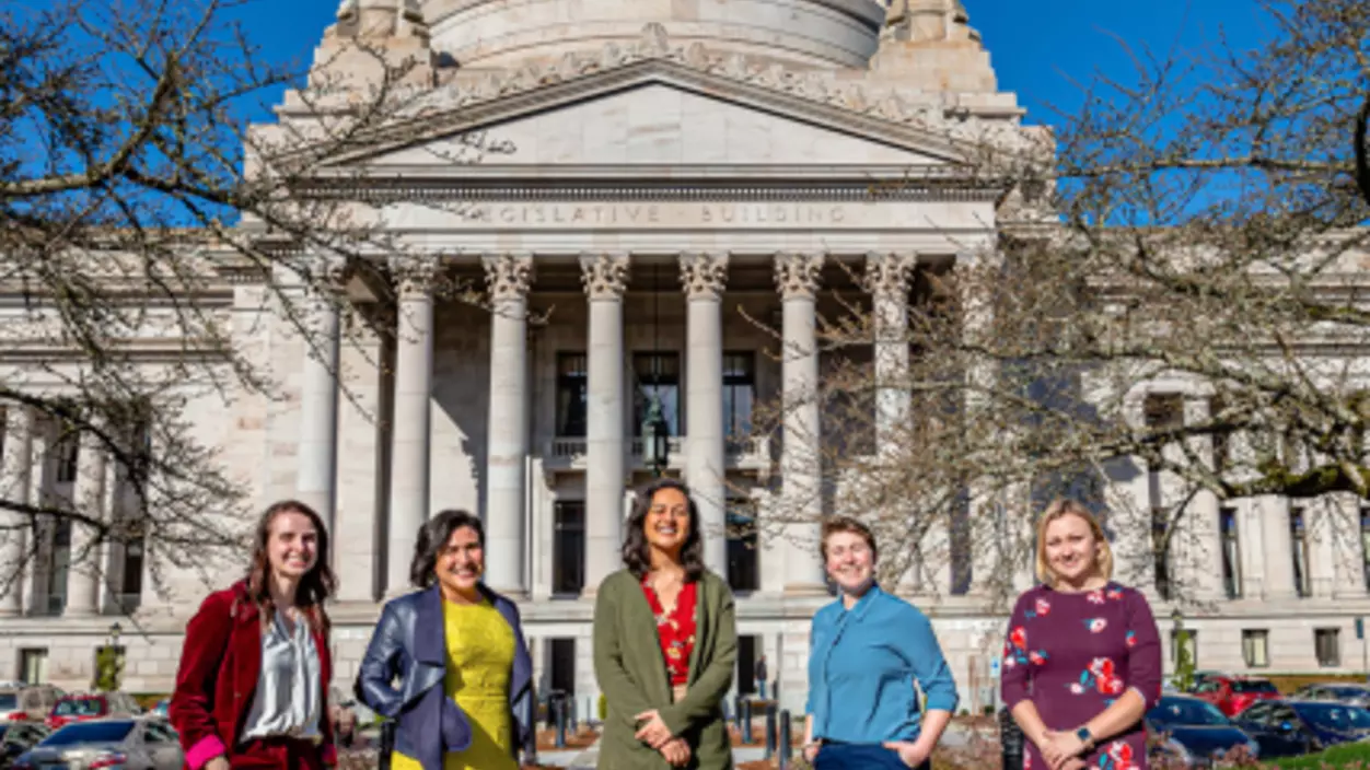 A group of women standing in front of a building