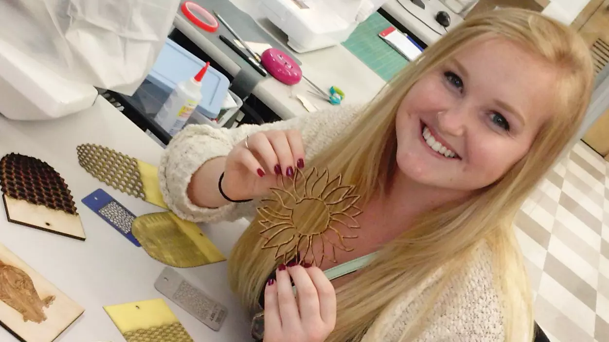 Student holding an acrylic sunflower