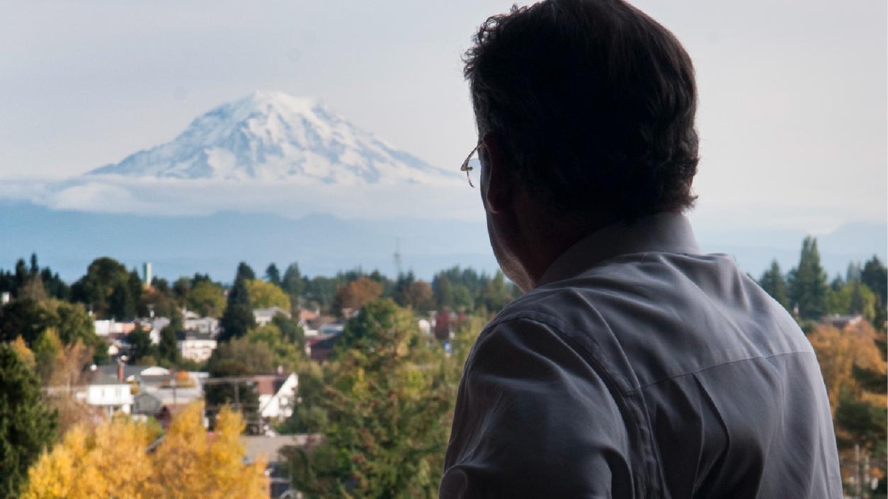 President Ron Thomas looks out at Tacoma and Mount Rainier.