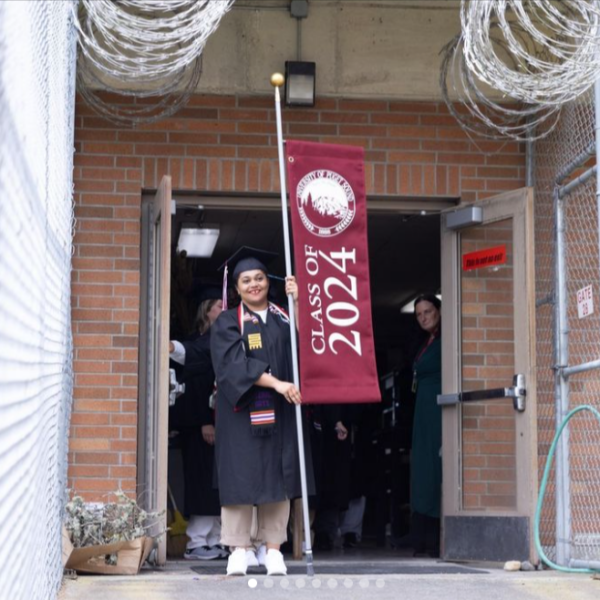 A graduate proudly carries the banner for the first FEPPS graduation.