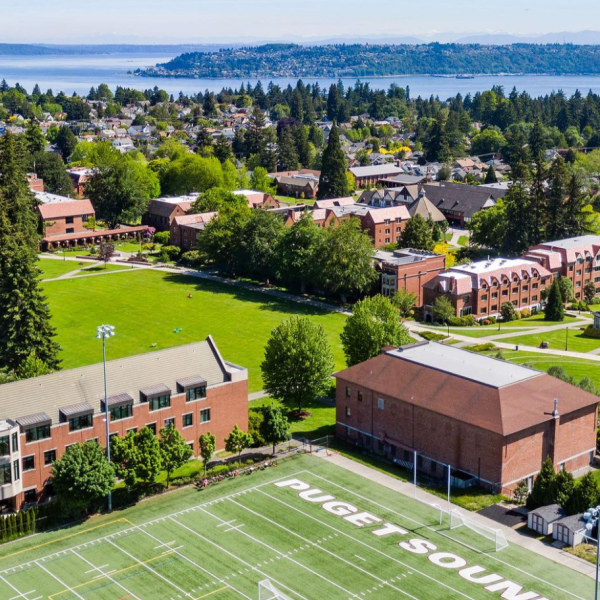 An aerial view of the Puget Sound campus with Commencement Bay in the background.