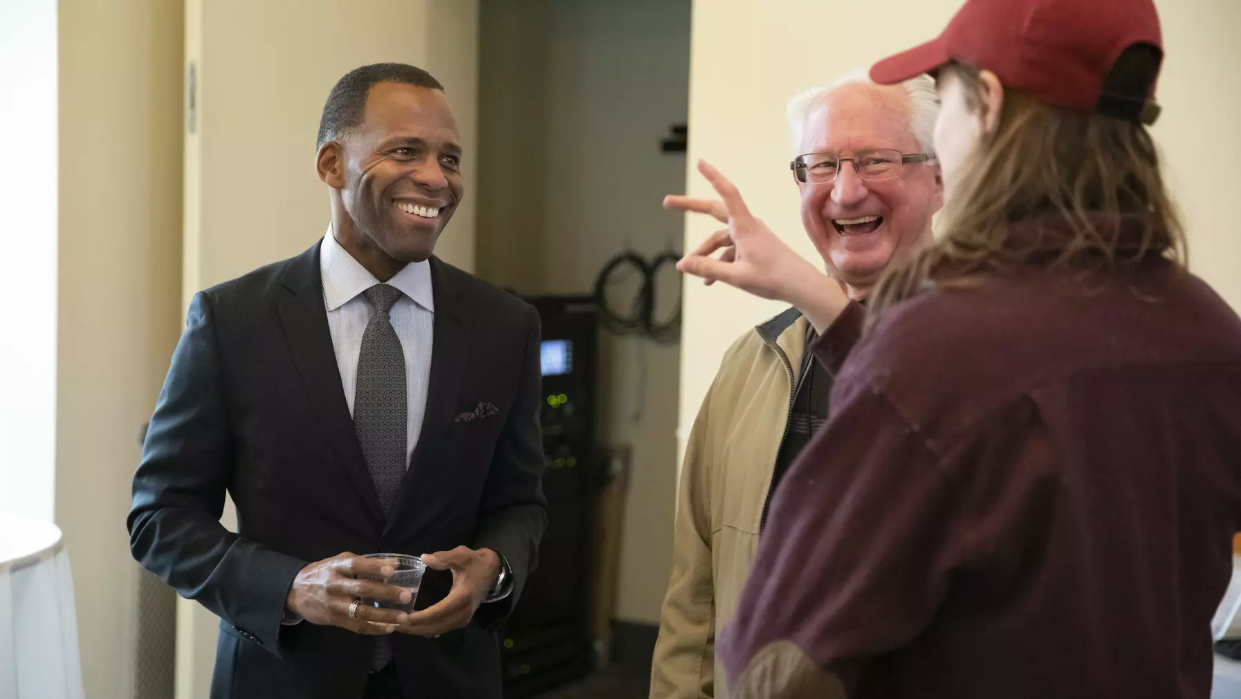 Three people talking and smiling