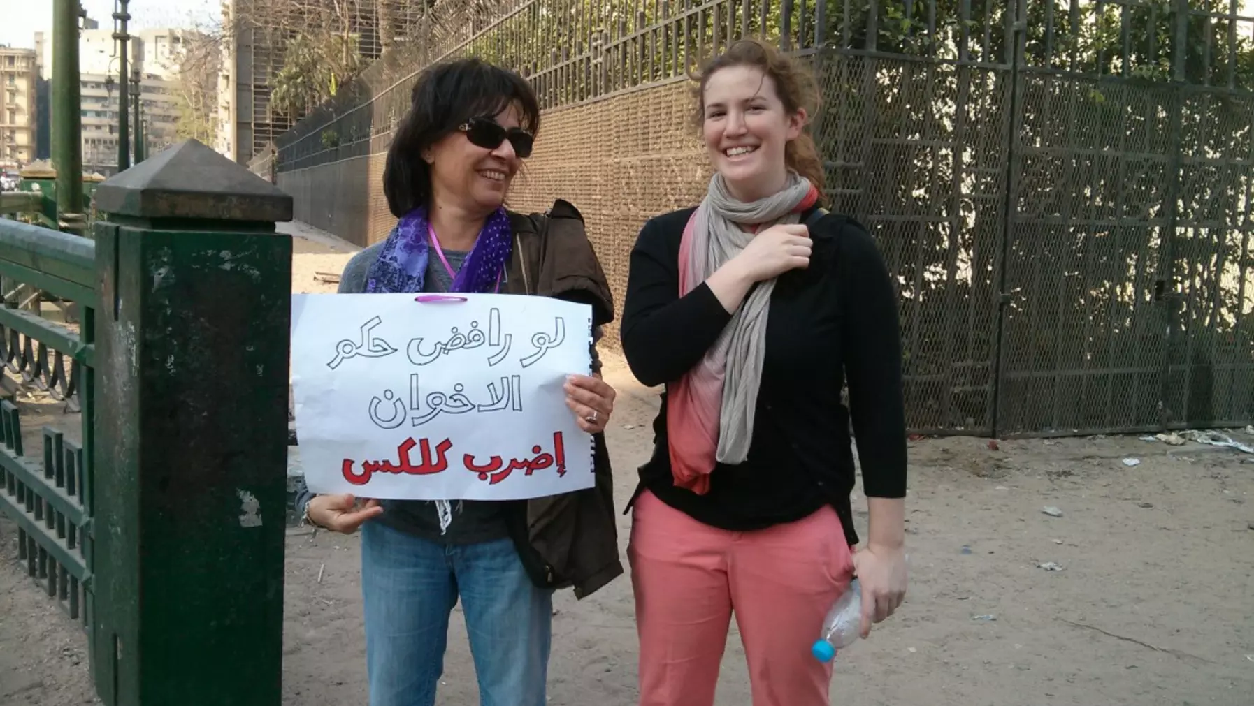 Maddie Waddell '14 poses with a demonstrator during her Summer Research Award in Egypt,