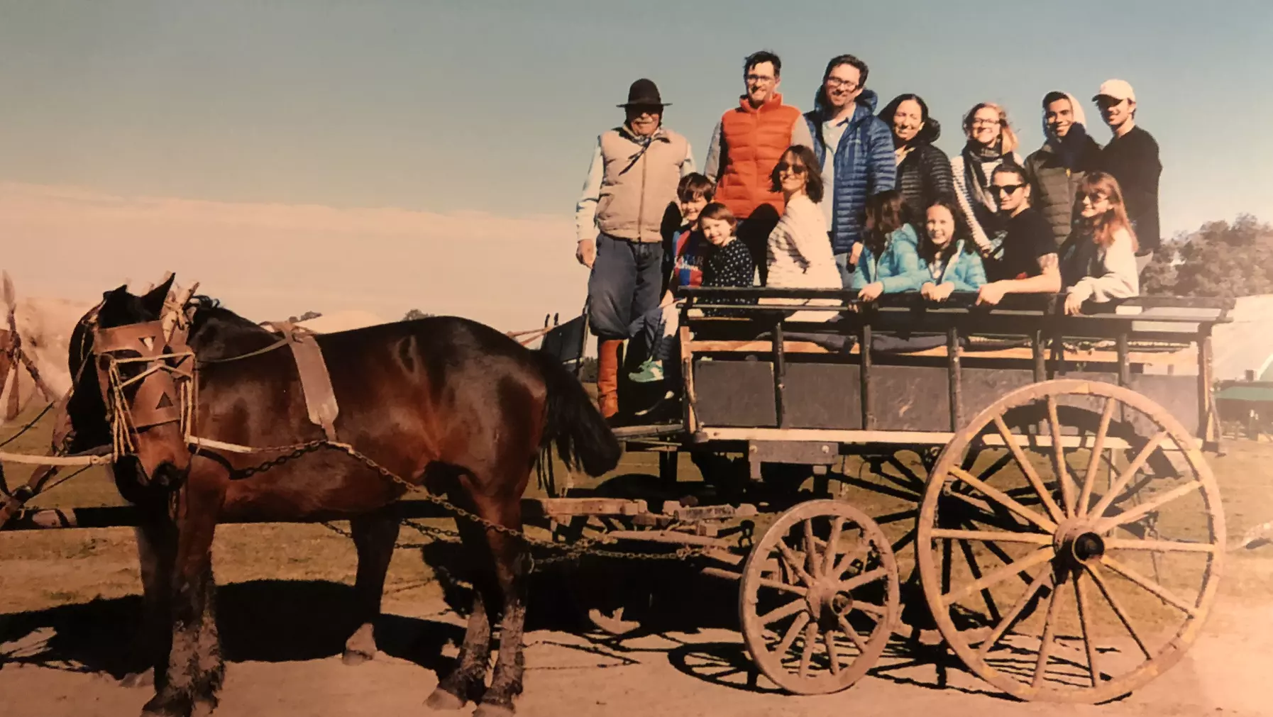 A group of people in a horse-drawn cart