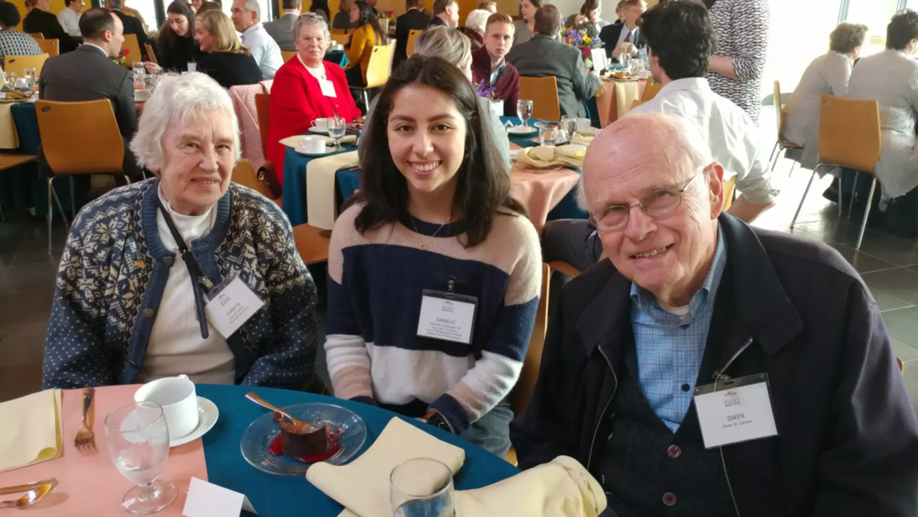 Three function attendees seated at a table