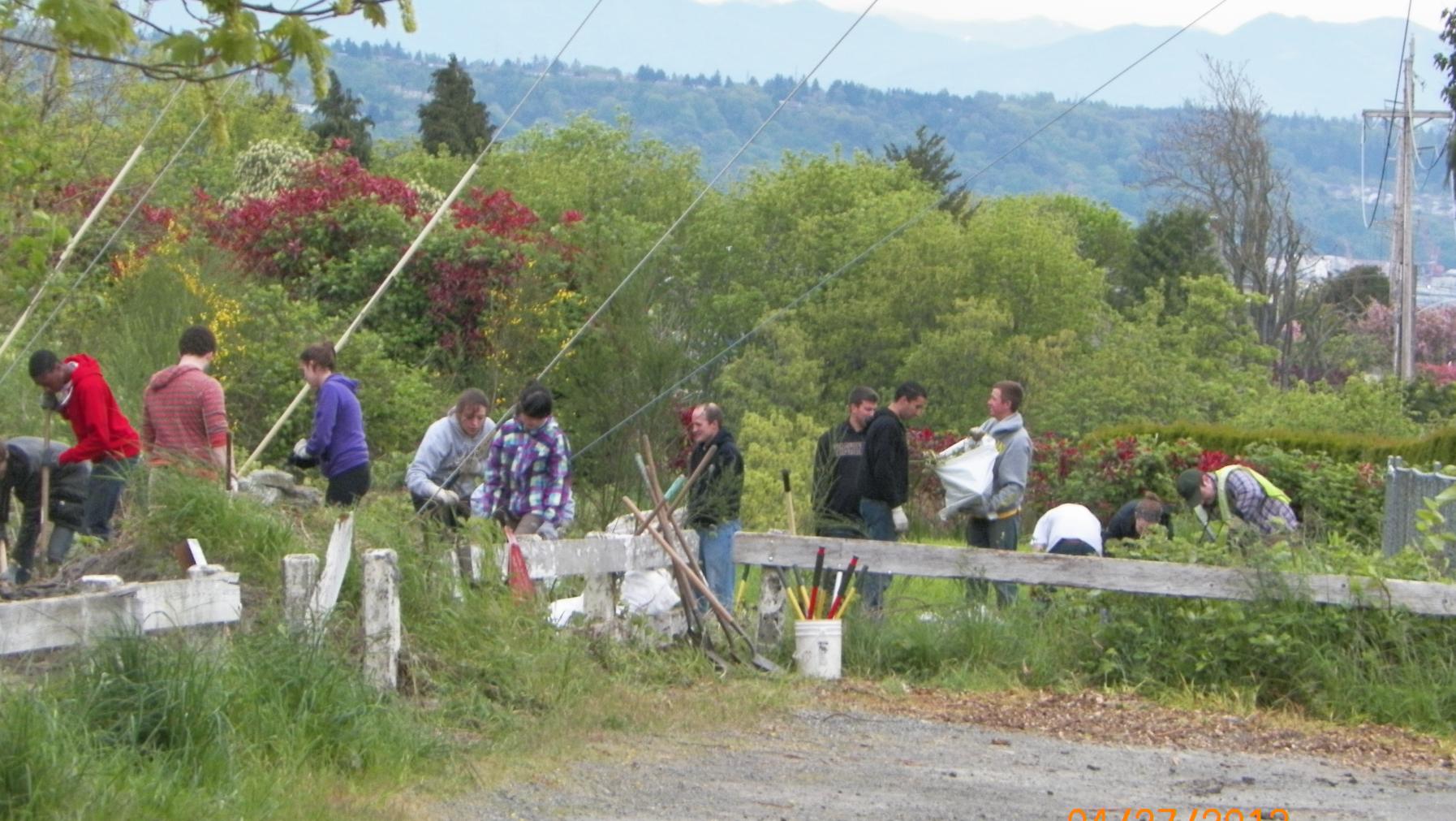 Large group of people with gardening equipment