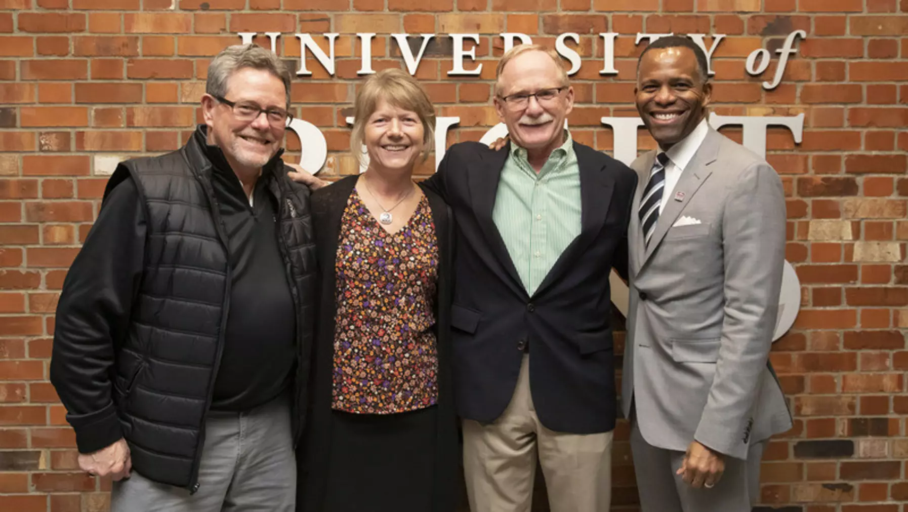 President Isiaah Crawford with three other people