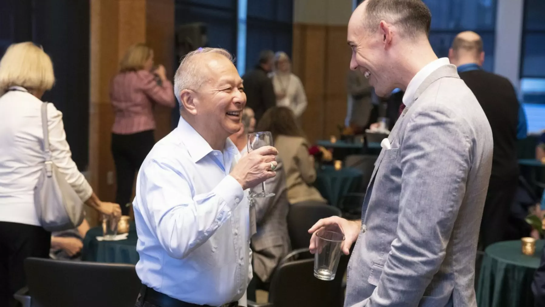 Two people smiling and talking together