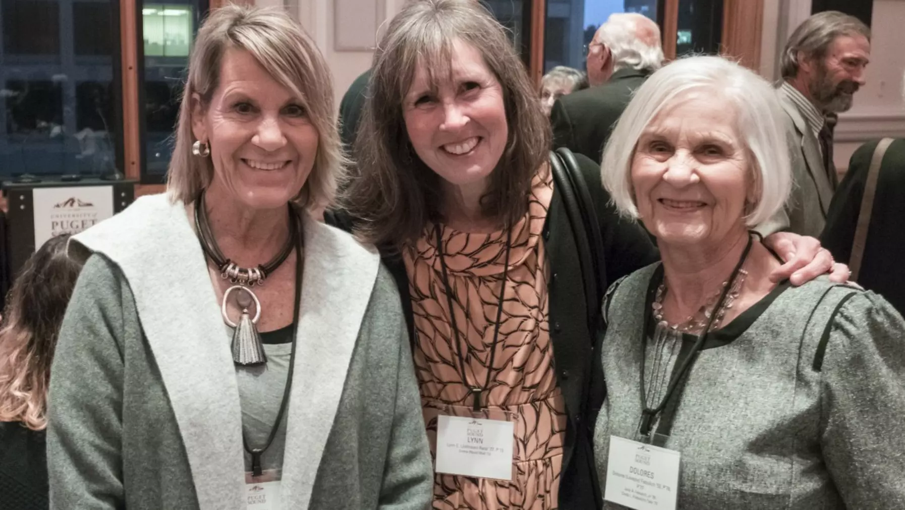 A group of three women smiling