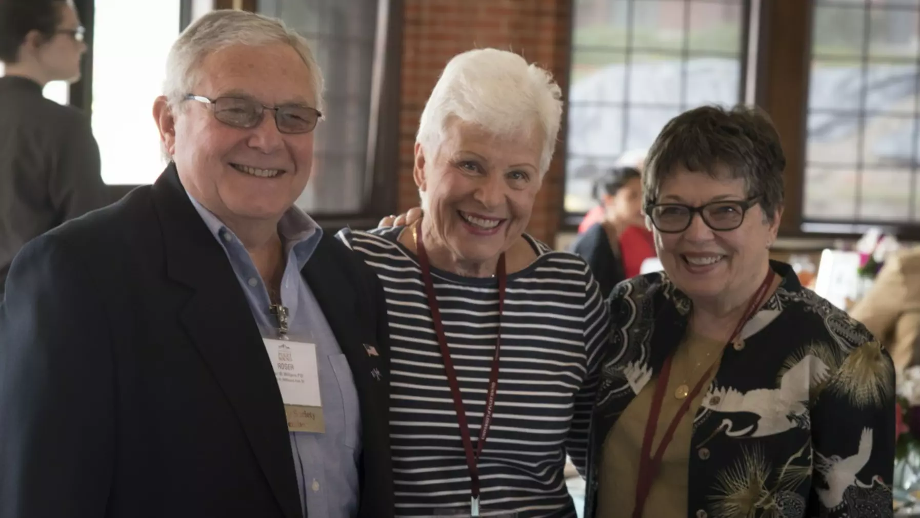 Three smiling function attendees