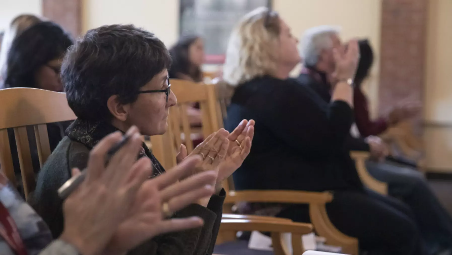 Audience members applauding