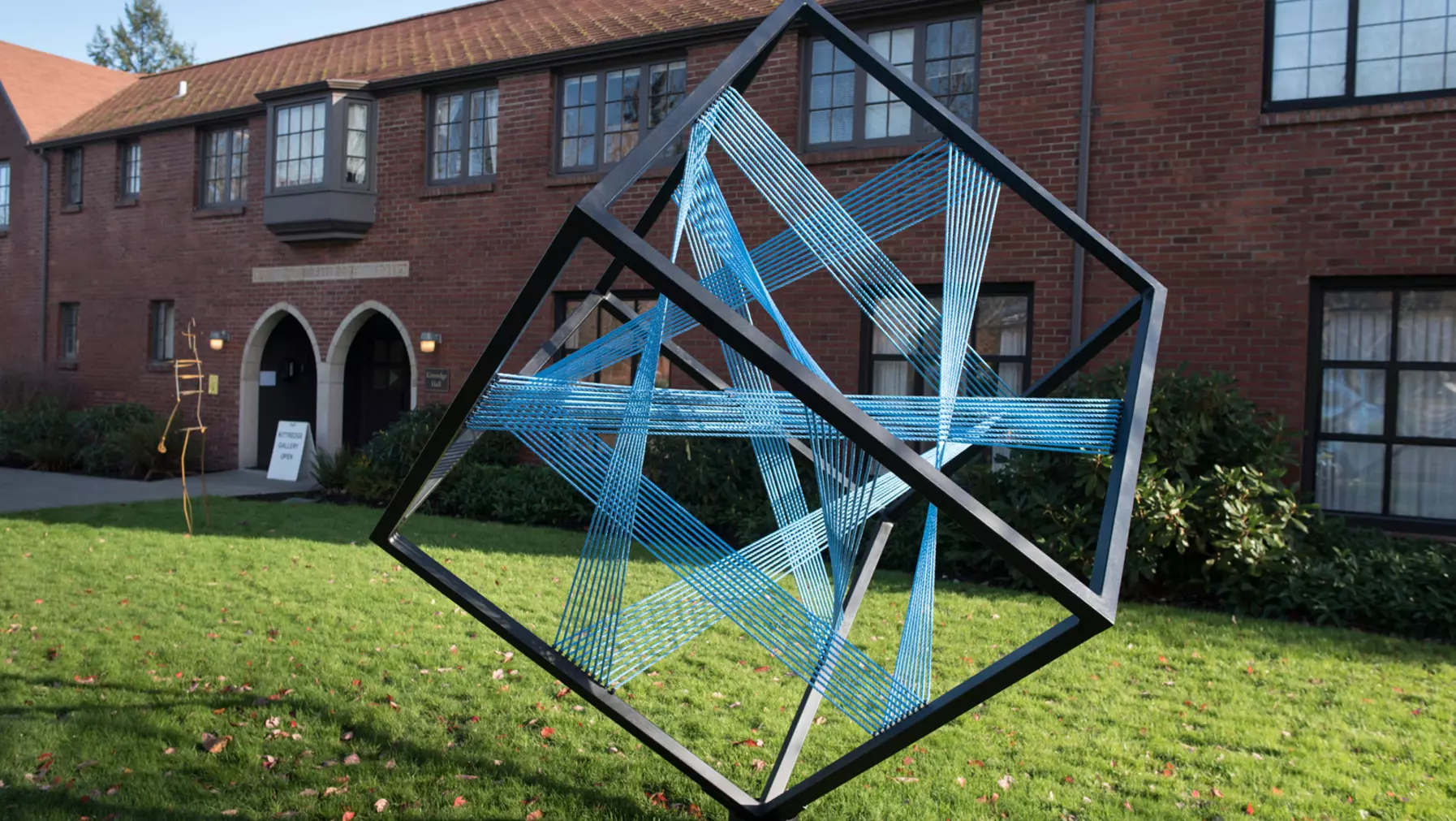 A 3D cube sculpture outside a university building