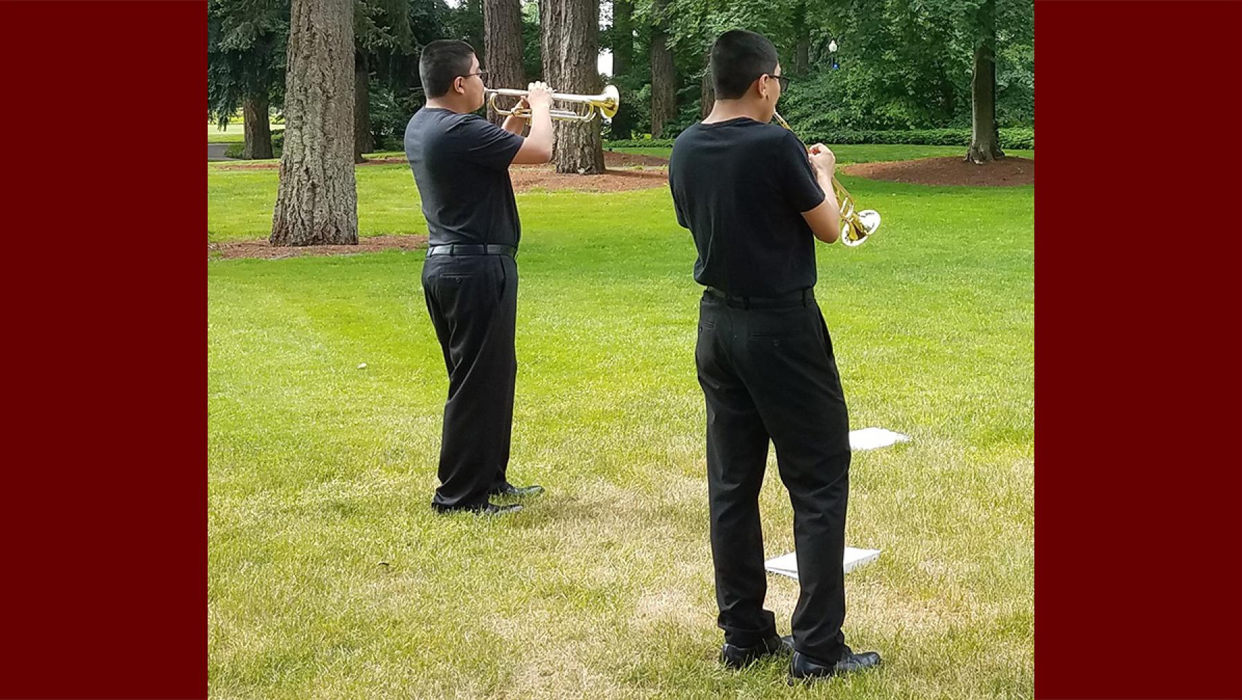 Brass Camp 2022 attendees playing trumpets on the lawn