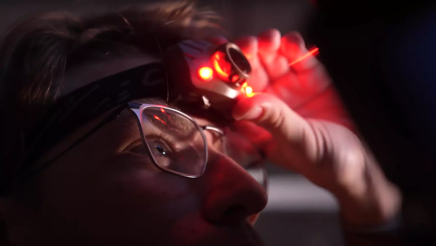 Austin Glock ’23 uses a red headlamp to see in the dark observatory dome.