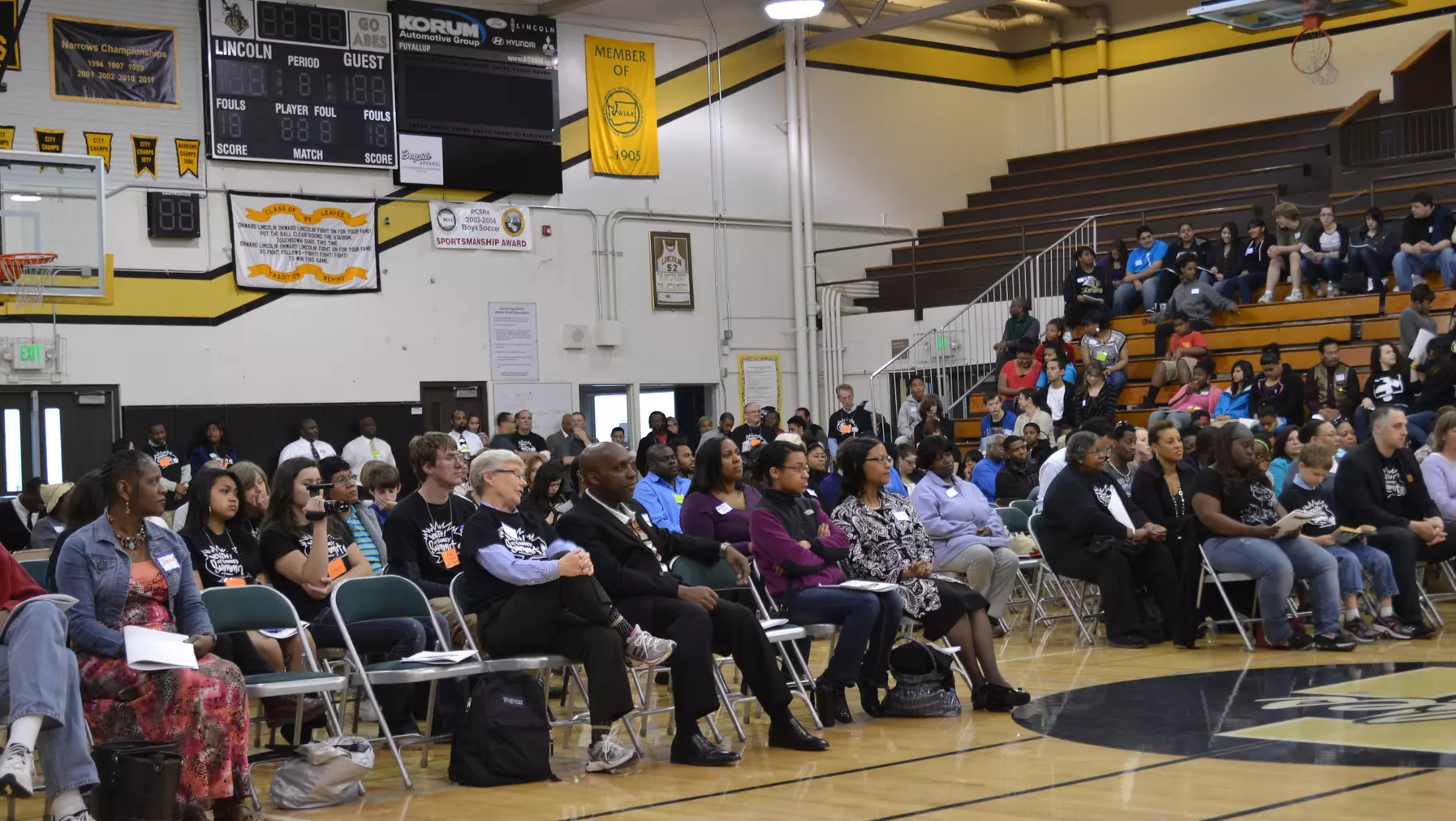 Students sitting in the fieldhouse