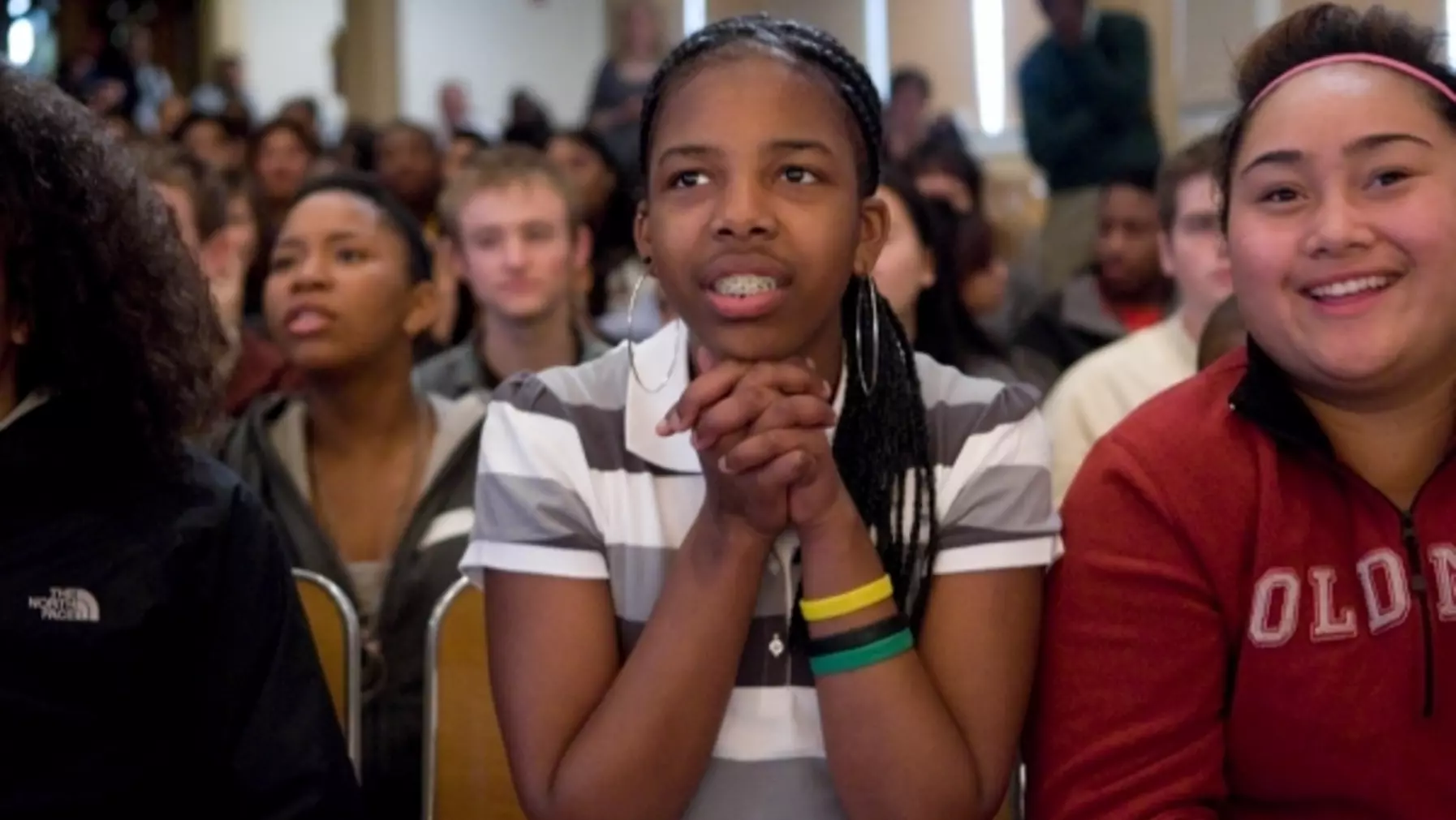 Student clapping and smiling