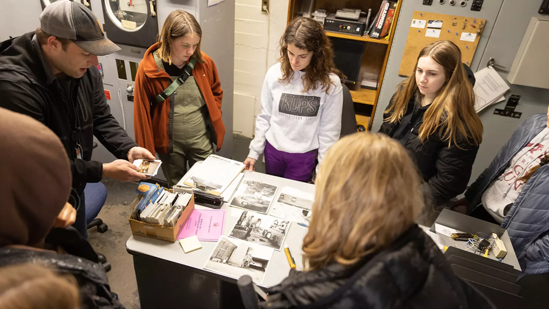 Students looking at prison archives ephemera