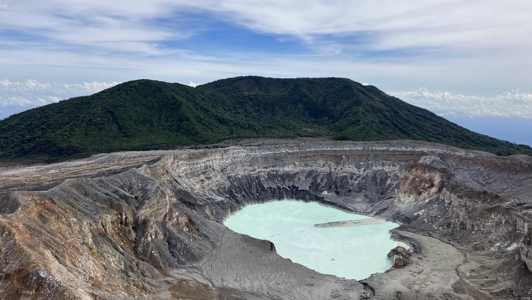 A volcanic landscape, including a bright blue lake, in Costa Rica, taken on a Georneys trip in 2023.