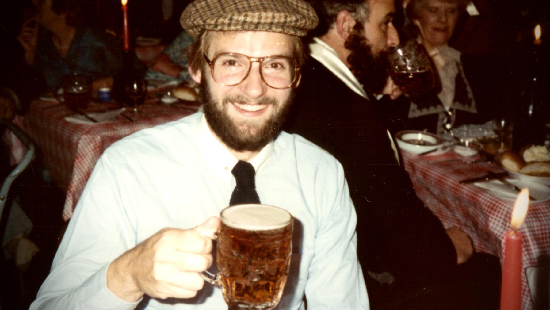 James Robert Hanssen smiles, holding a beer.