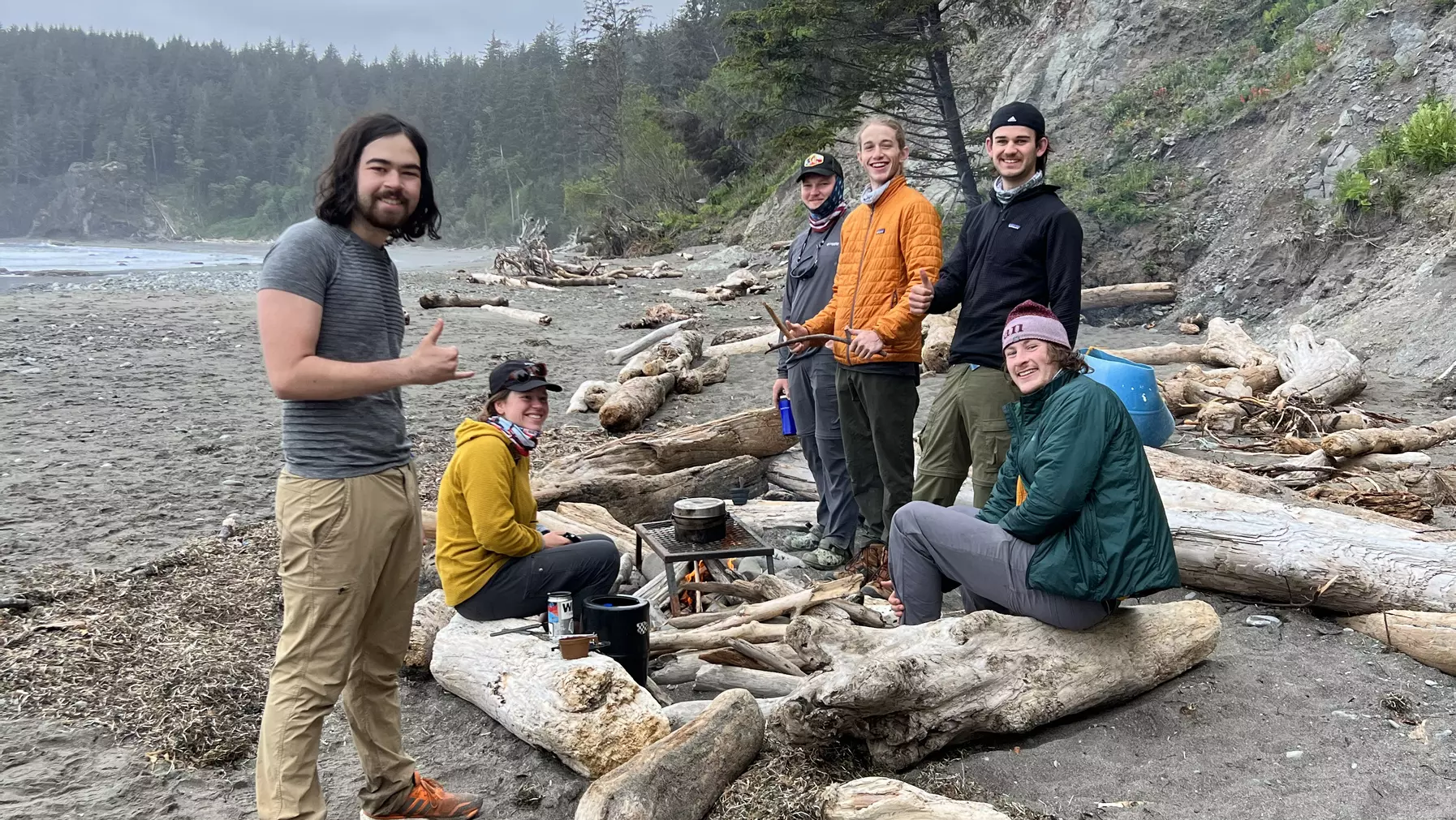 PacTrail students gather around a campfire on the beach the Washington coast.