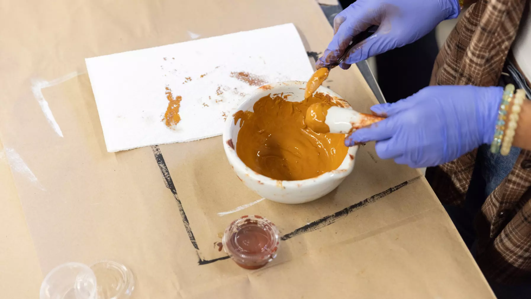 Making ochre with a mortar and pestle.