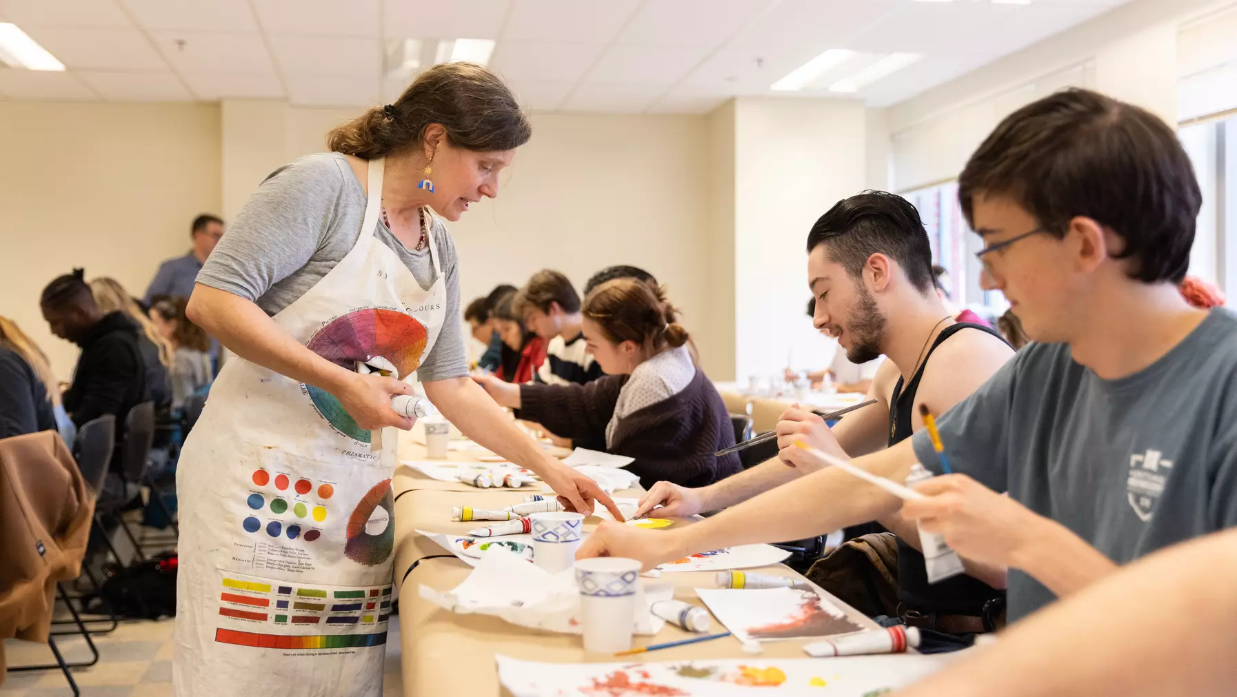 Prof. Elise Richman gives feedback during a painting session.