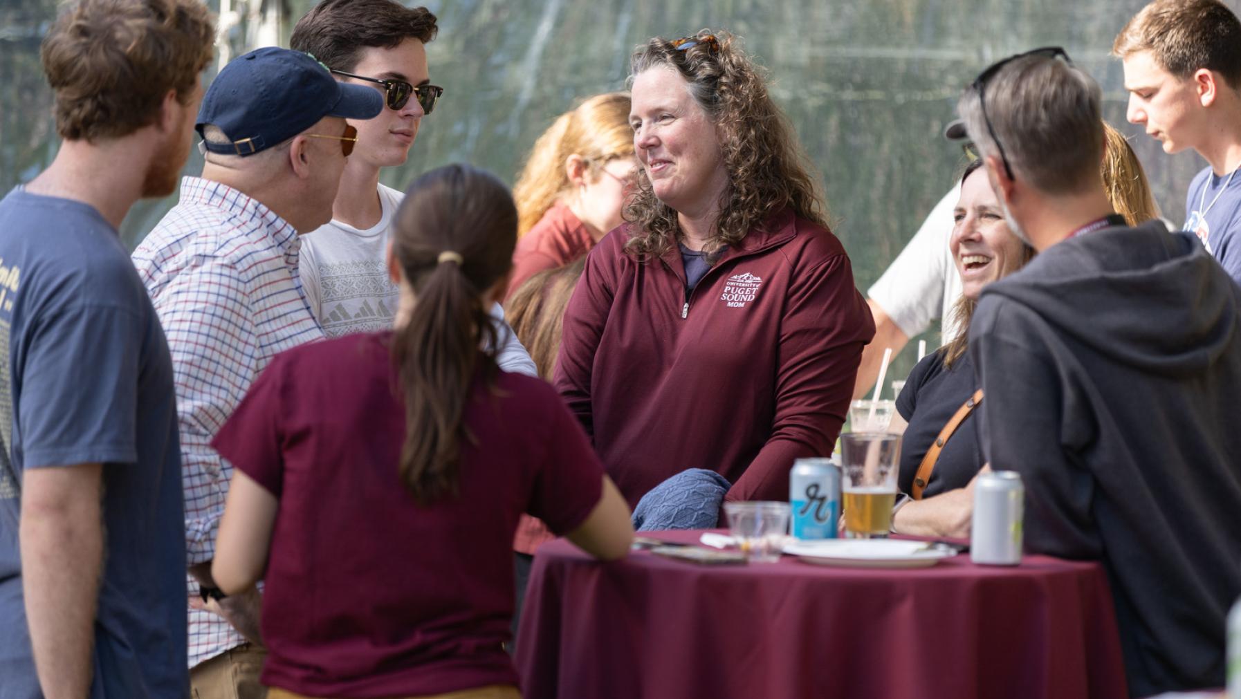 Attendees mingle at a reception during Homecoming & Family Weekend 2023.
