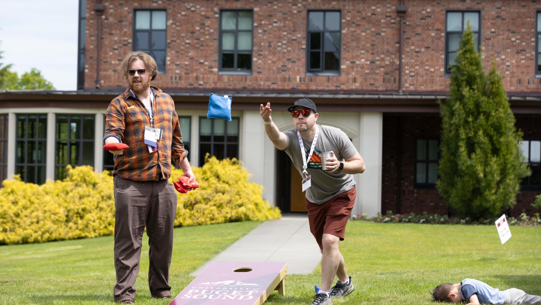 Logger alumni play cornhole during a Summer Reunion Weekend barbecue.