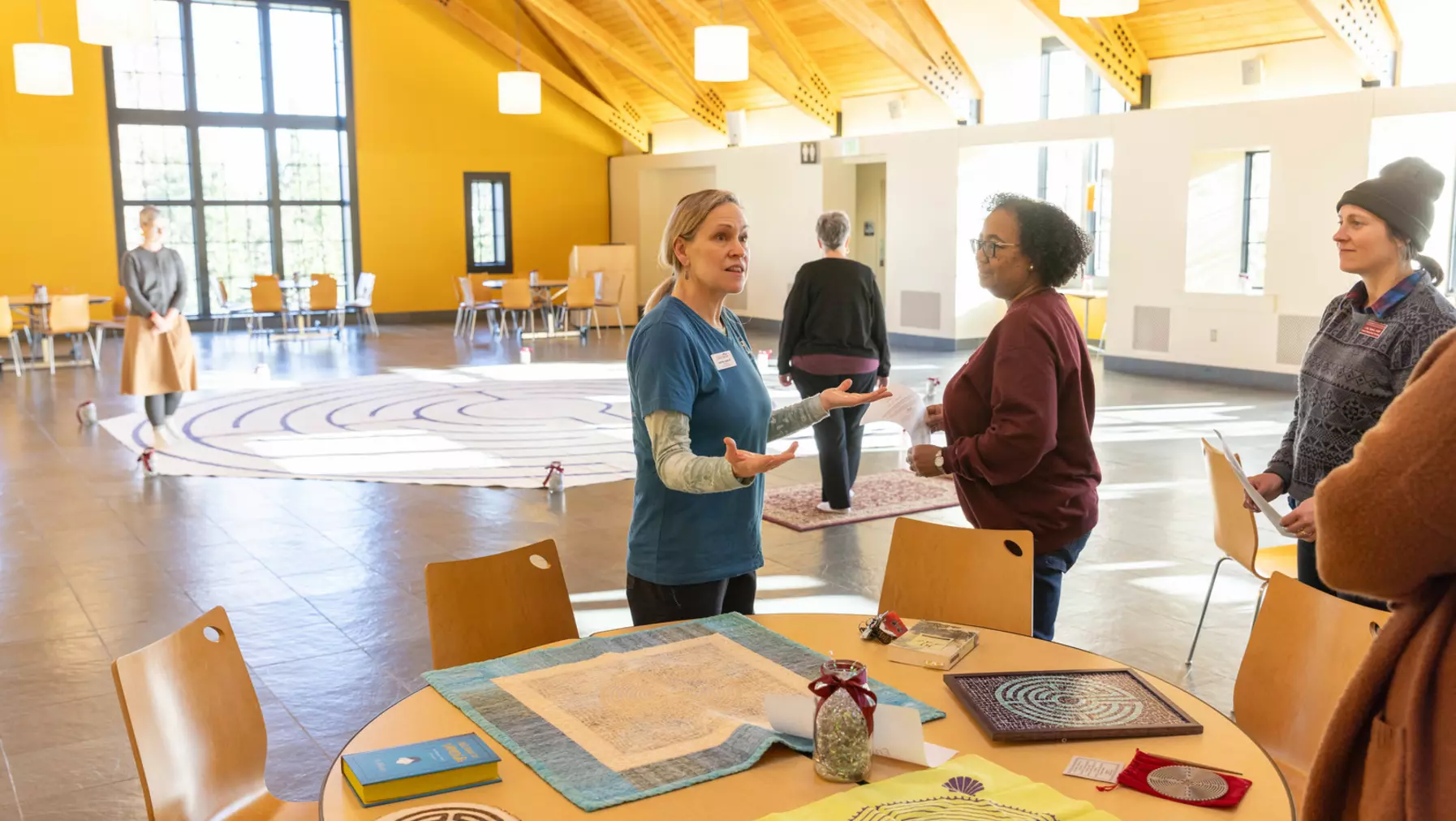 Woman speaking to people around a table