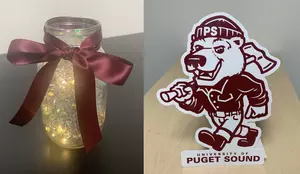 Table centerpiece (clear mason jar filled with crinkle paper and string lights and tied with a maroon bow) and a table top Grizz cutout