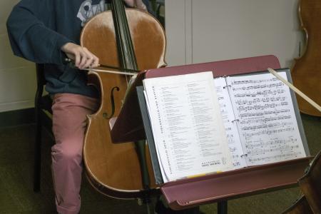 Sheet music and person playing cello