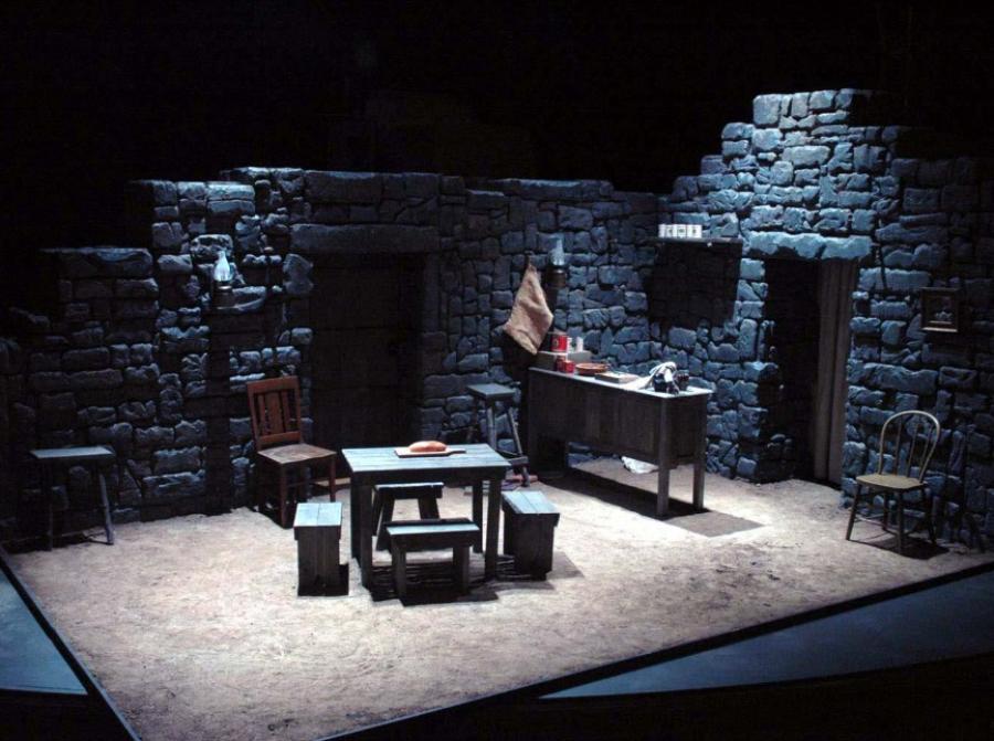 Stage set of the inside of a cobblestone home